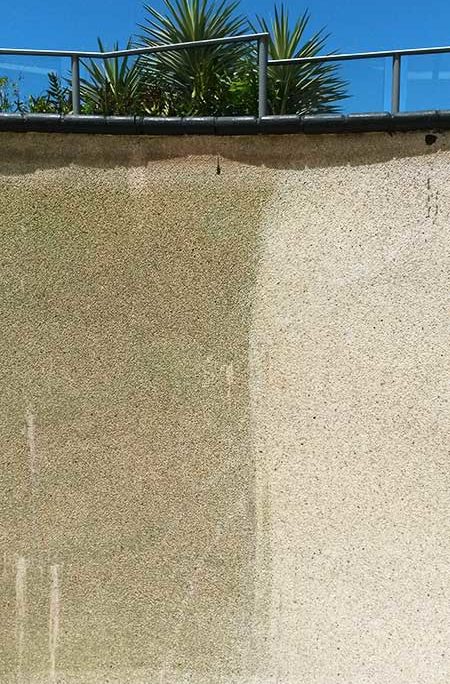 Calcium deposits mark the wall of a swimming pool that needs acid washing