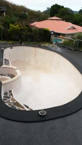 Drained swimming pool during acid washing process